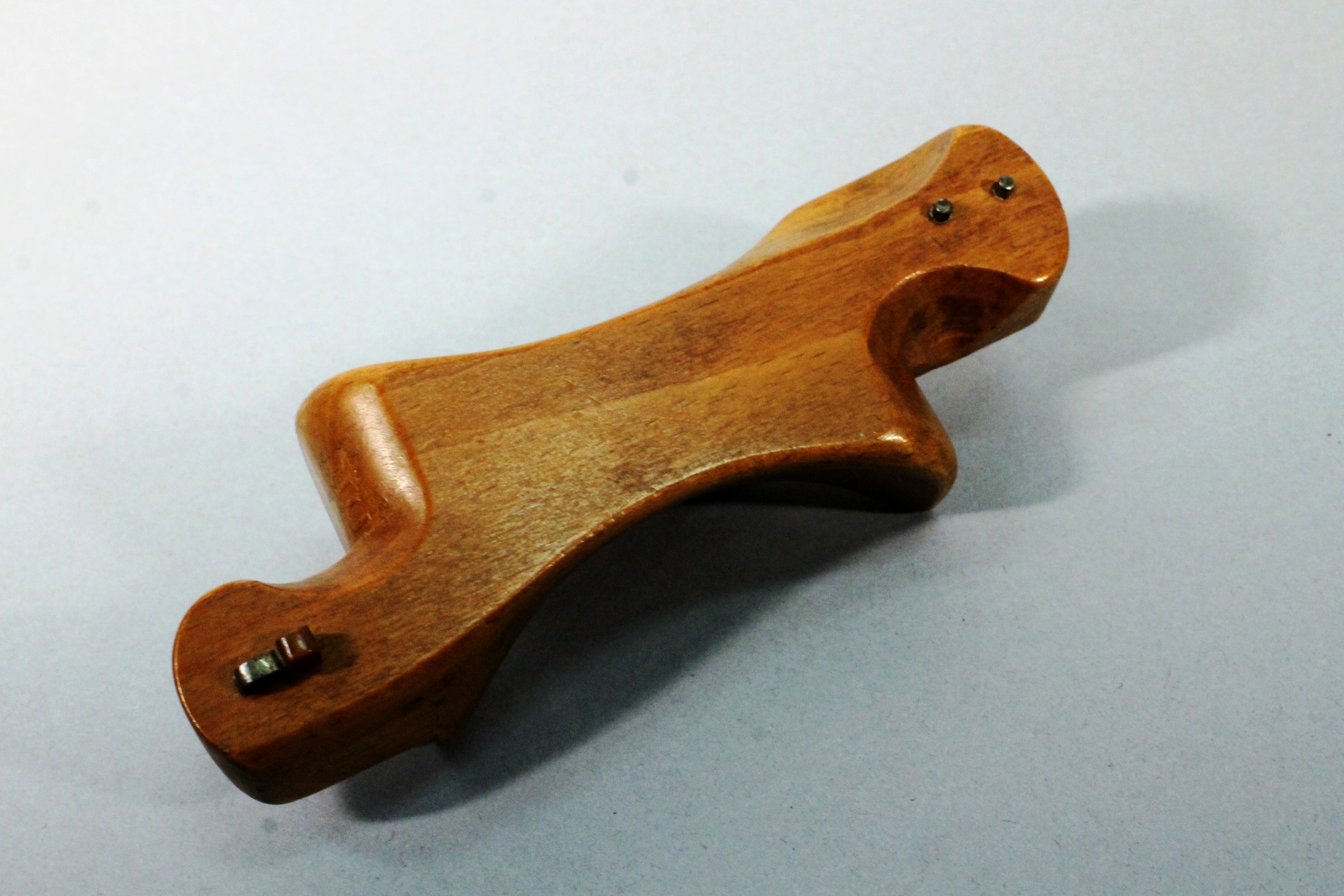 A piece of wood with a screw on it.