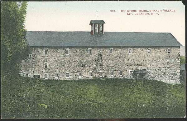 An old postcard shows a stone building on a hill.