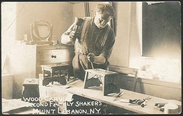 An old photo of a man in a workshop.
