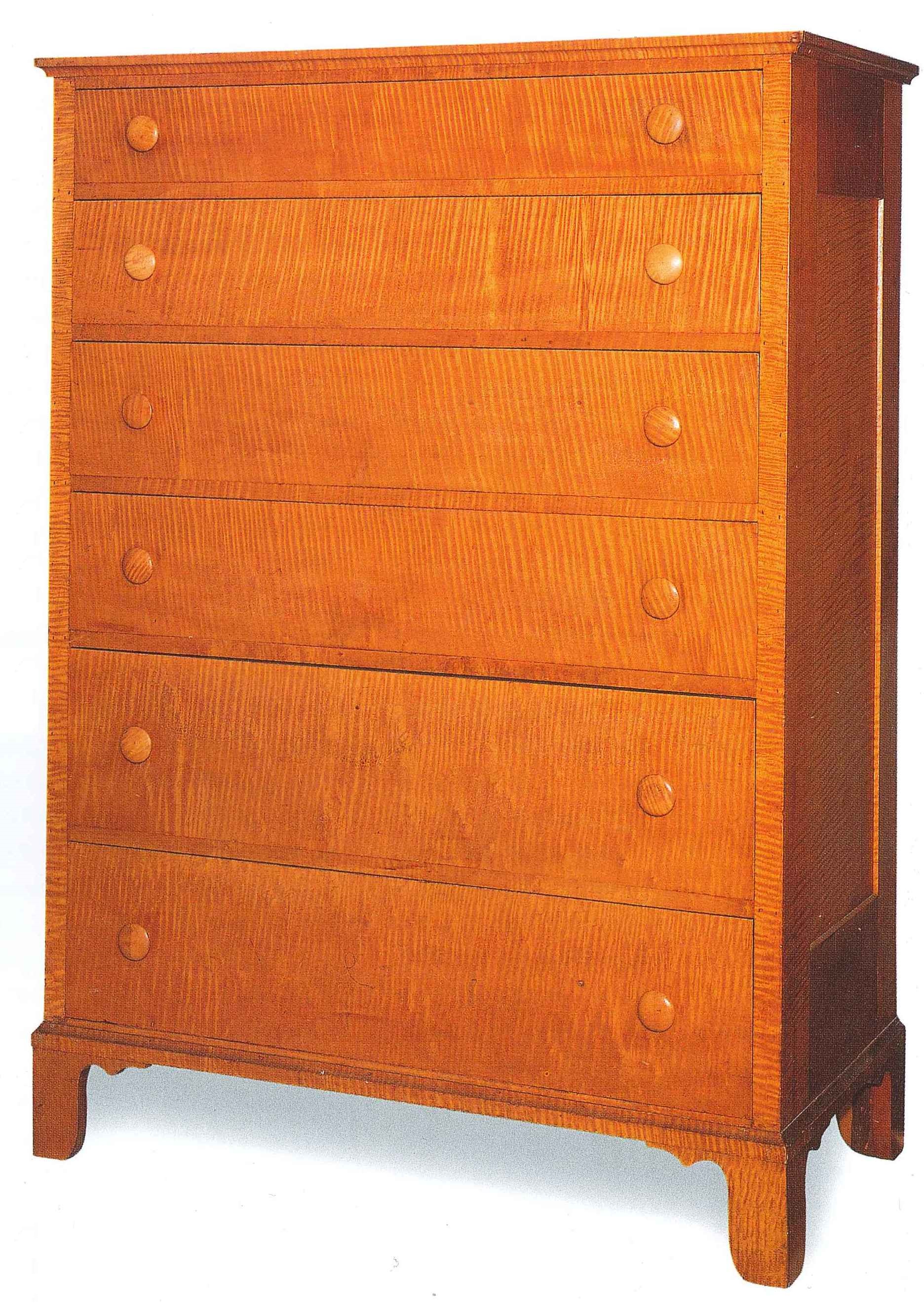 A wooden chest of drawers on a white background.