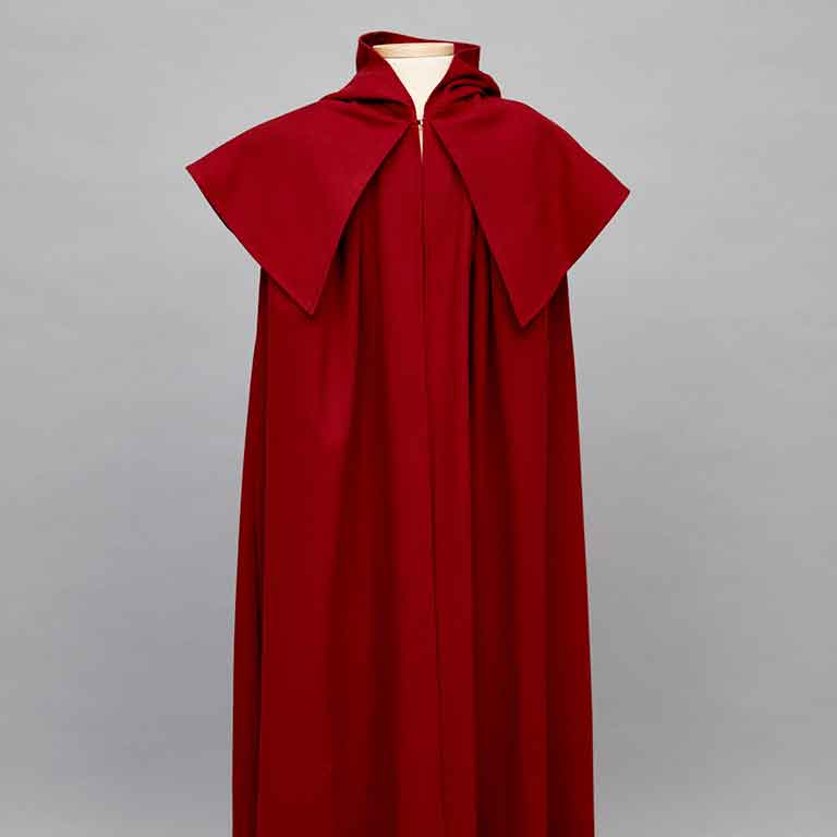 A red cloak on a mannequin.