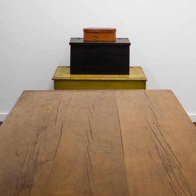 A wooden table in a room with a box on it.