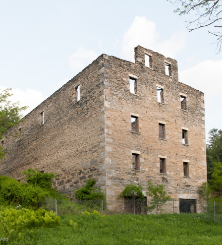 An old brick building on a hillside.