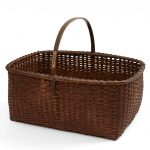 A brown wicker basket on a white background.