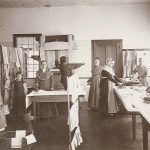 A group of people standing around a table.