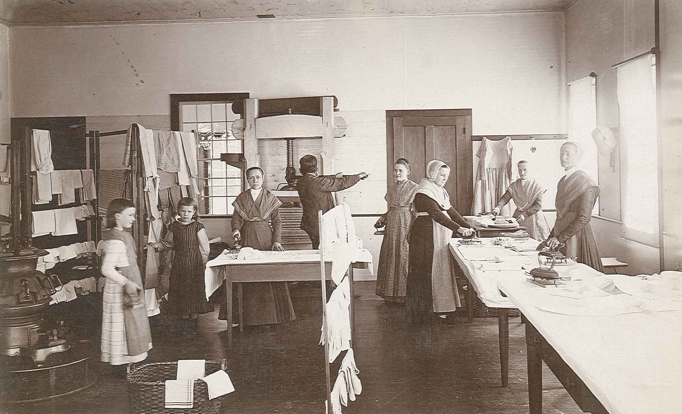 A group of people standing around a table.