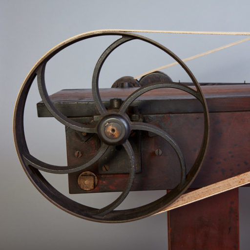 A machine with a wheel on top of it.