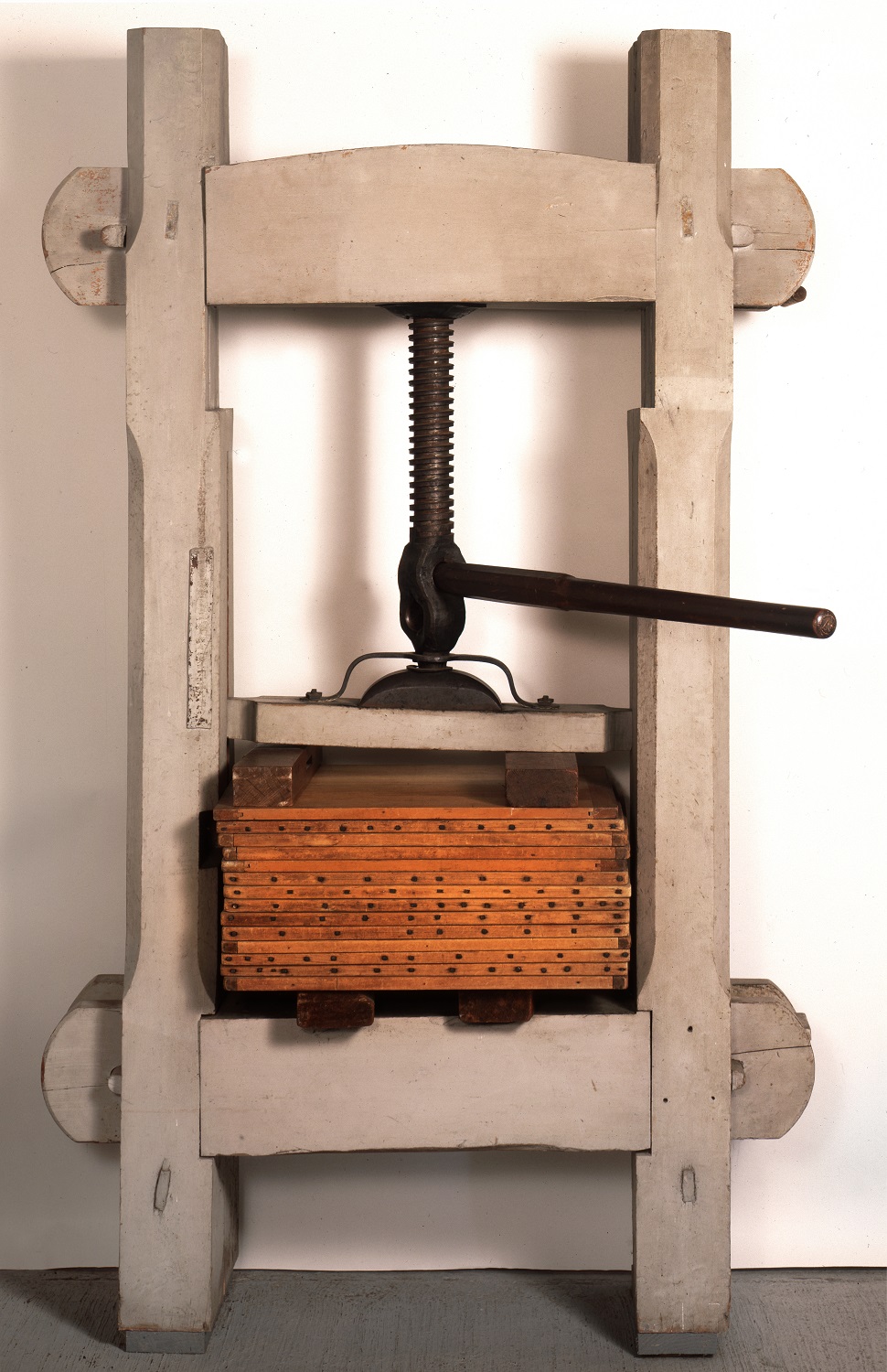 A wooden press with a wooden box on it.