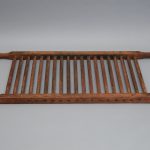A wooden tray with a wooden handle.