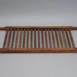 A wooden tray with a wooden handle.