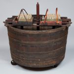 A wooden barrel with a lot of sticks in it.