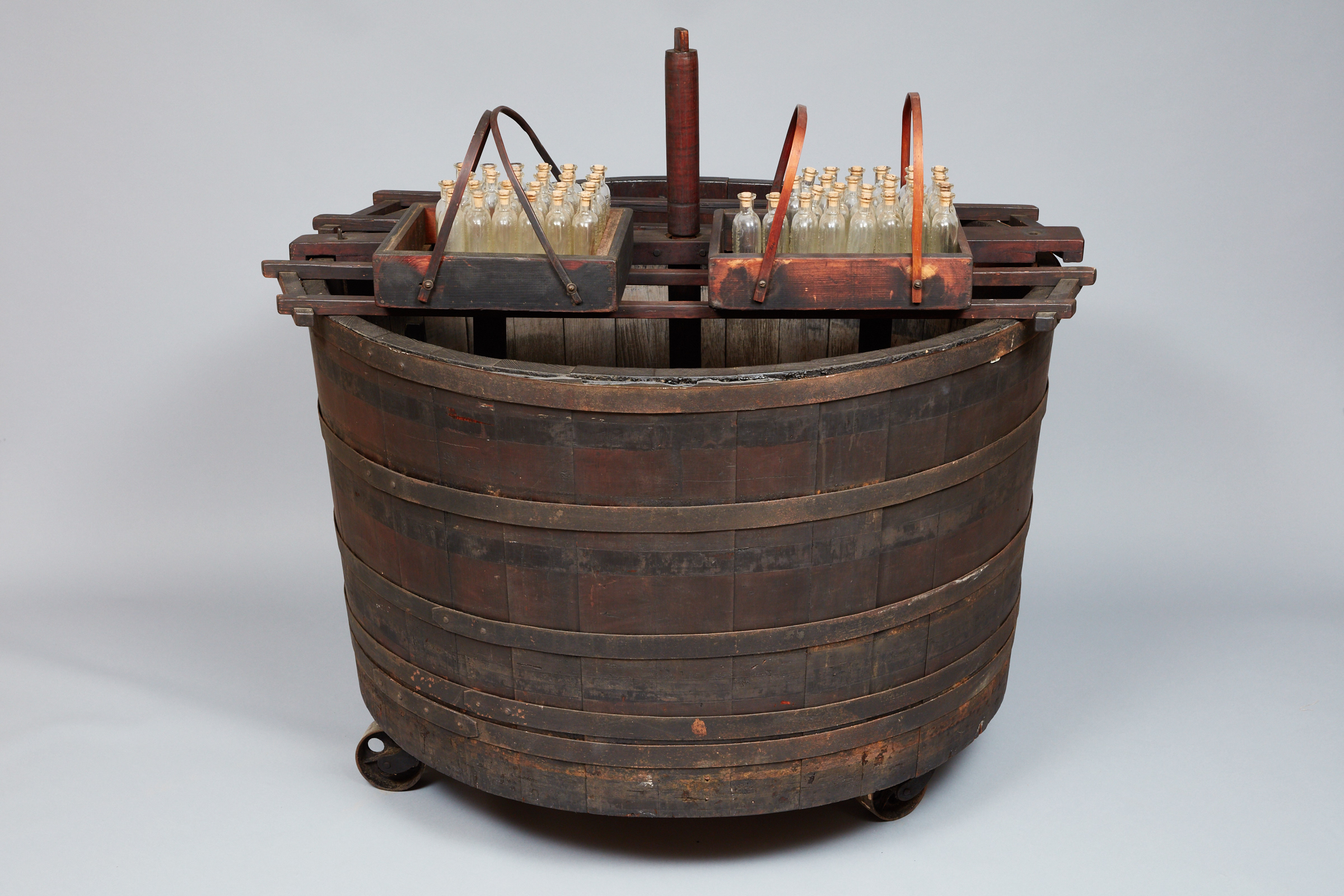 A wooden barrel with a lot of sticks in it.