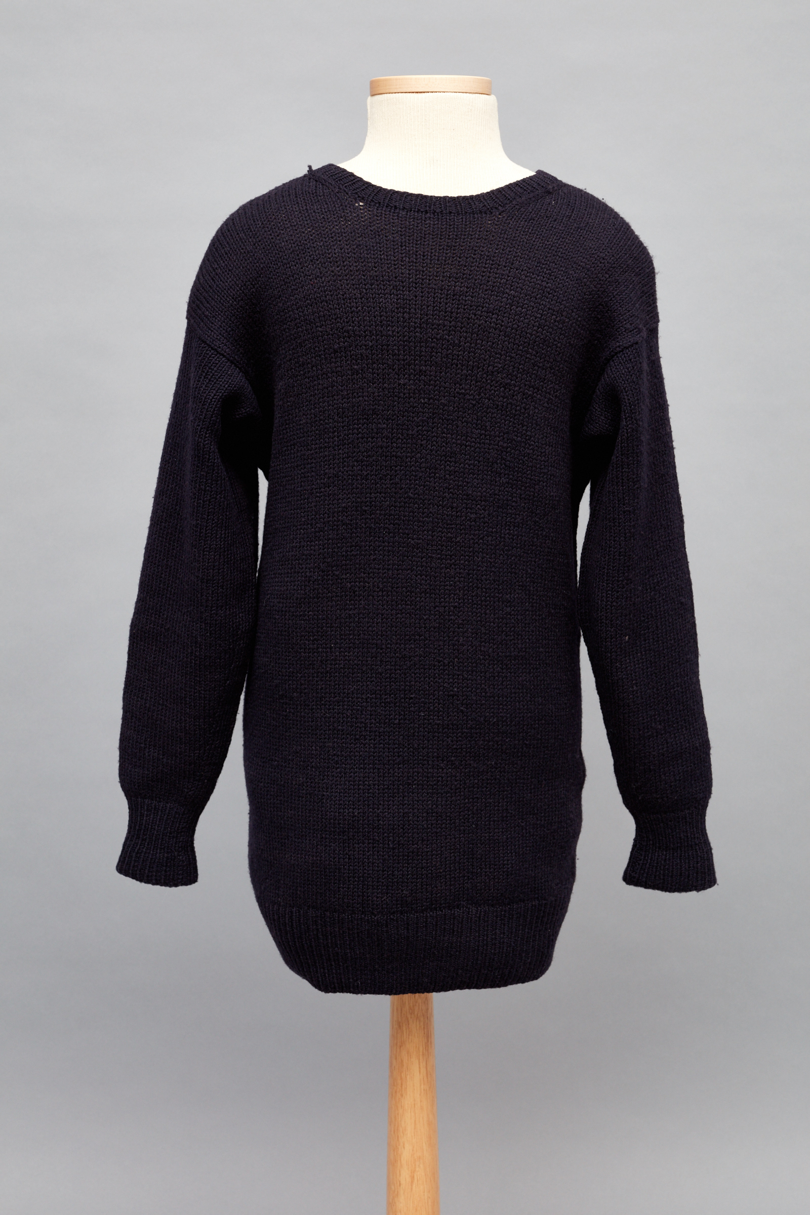 A black sweater on a wooden mannequin.