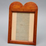 A wooden frame with a checkered pattern.