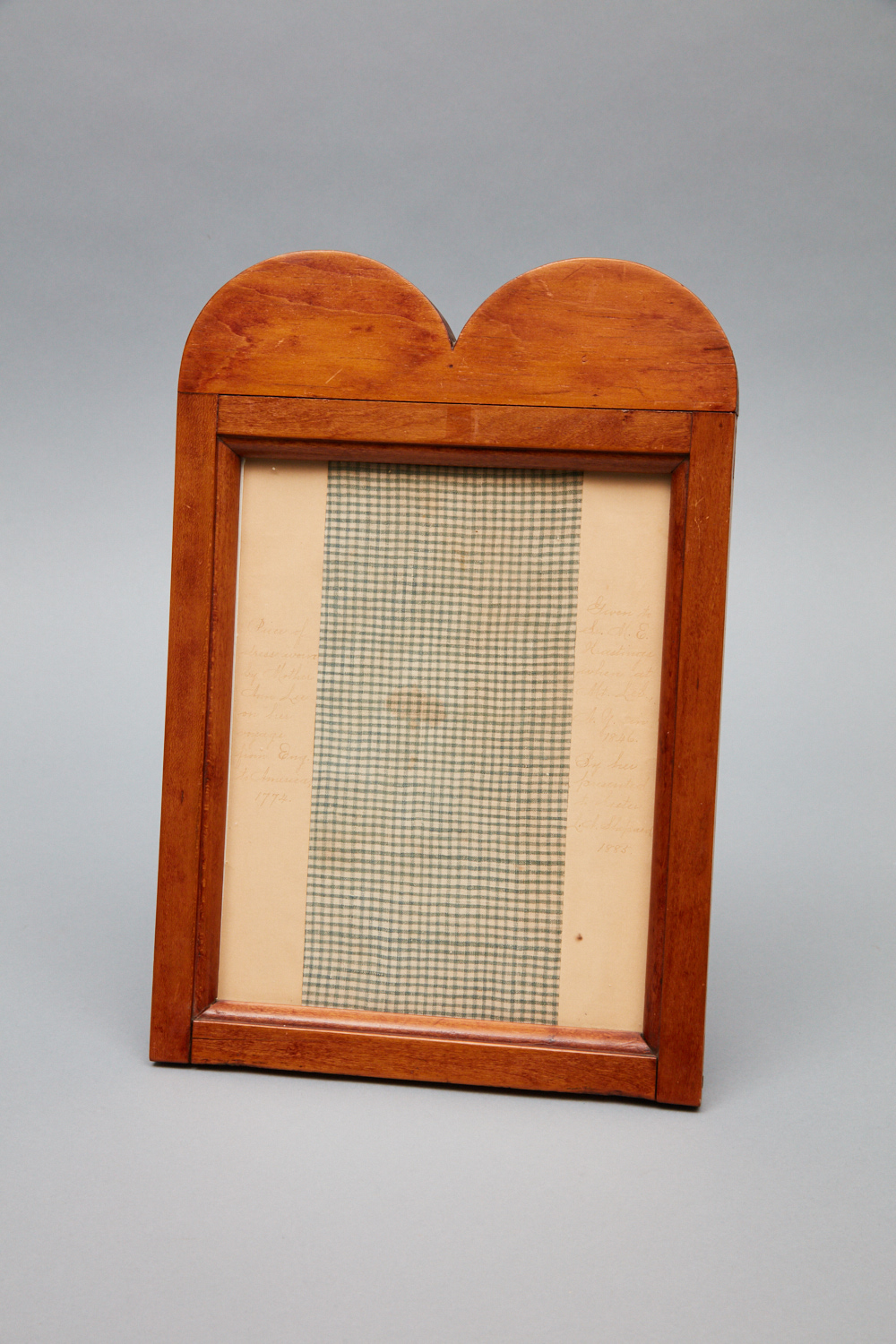A wooden frame with a checkered pattern.