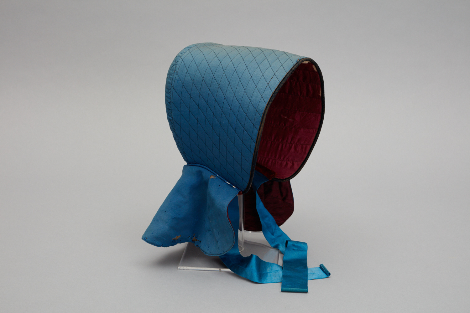 A blue and red hat on a stand.