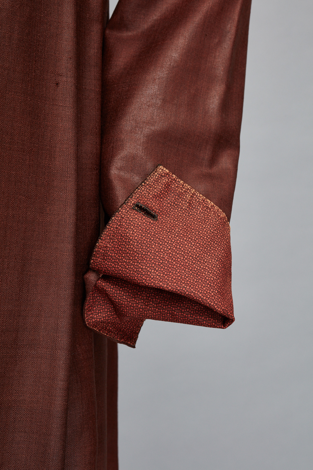 An image of a brown jacket with a pocket on it.