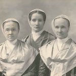 Three nuns posing for an old photo.