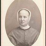 An old photograph of a woman in a striped dress.