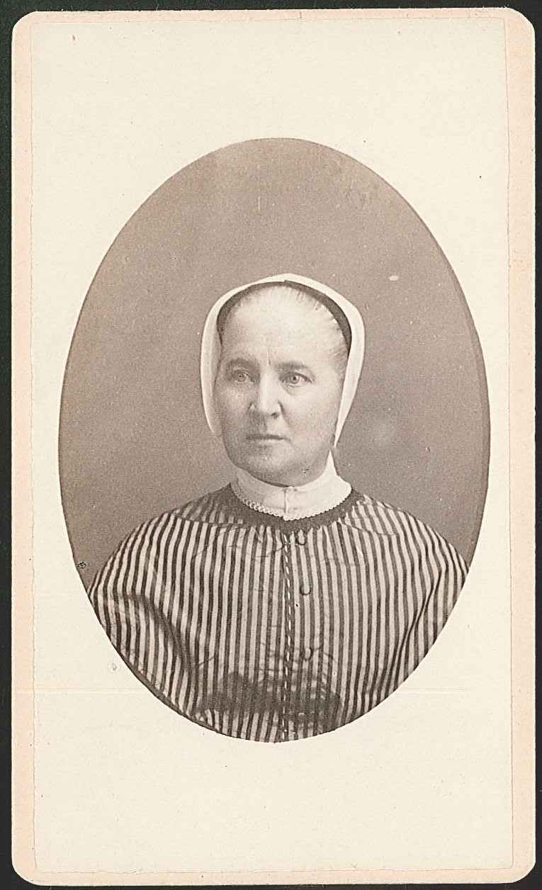 An old photograph of a woman in a striped dress.