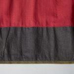 A red and black skirt with black trim.
