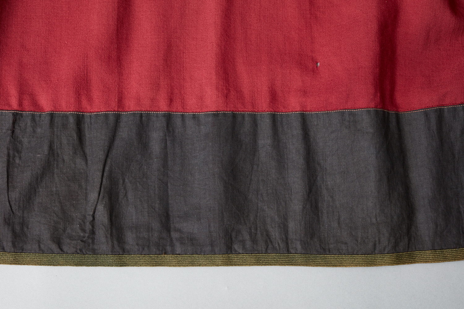 A red and black skirt with black trim.