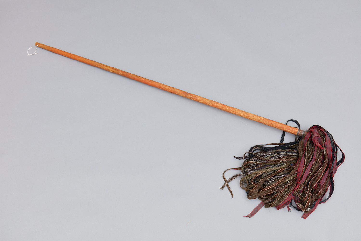 A wooden broom with a wooden handle.