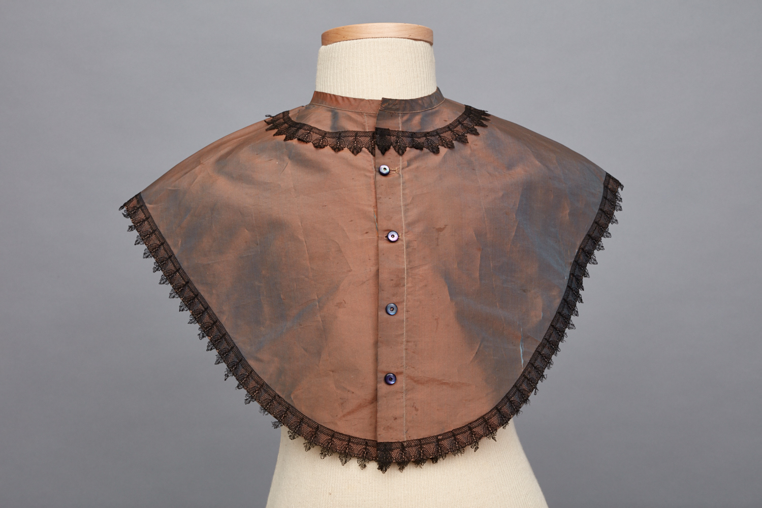 A brown shawl with black lace trim.