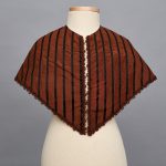A brown and black striped shawl on a mannequin.