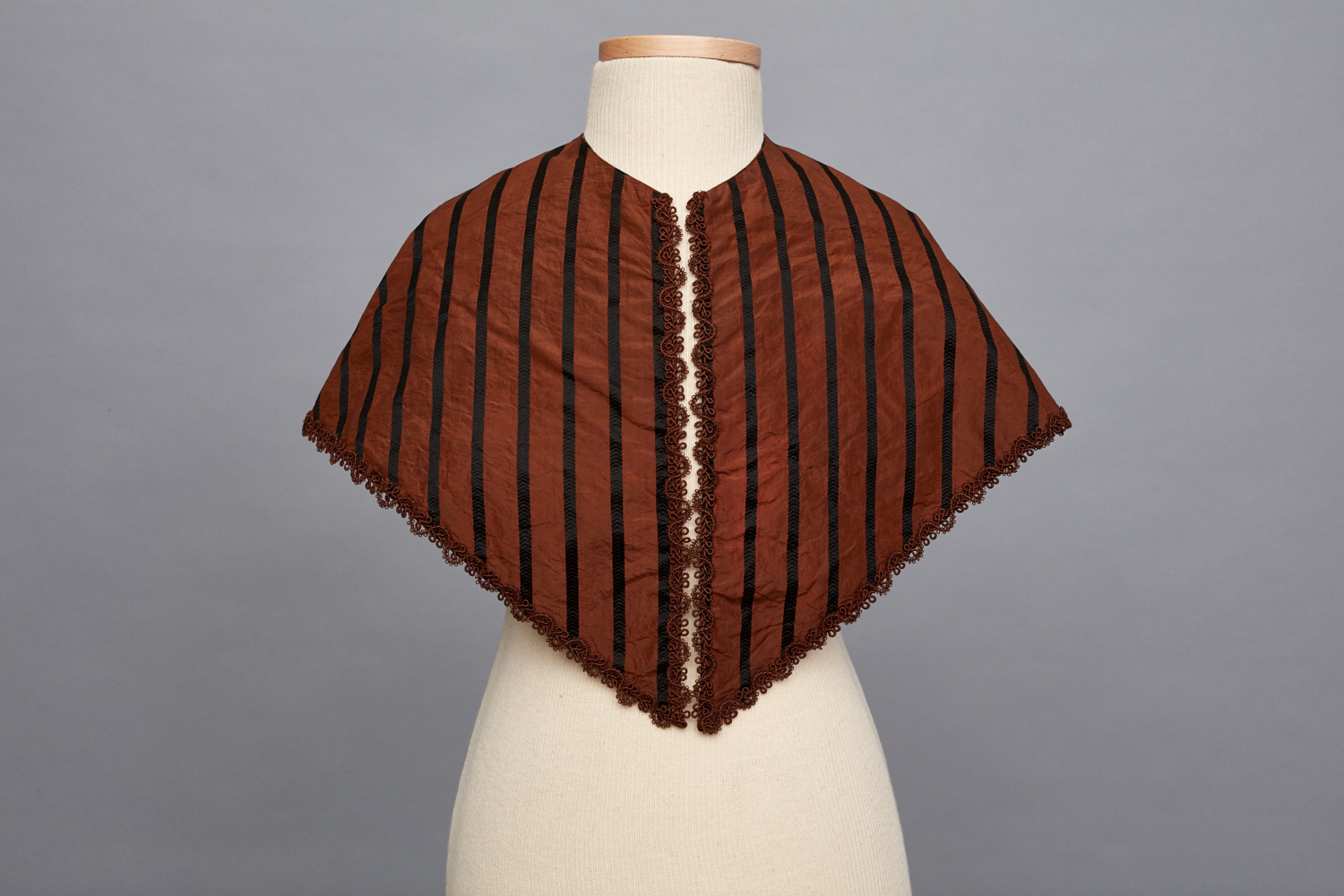 A brown and black striped shawl on a mannequin.