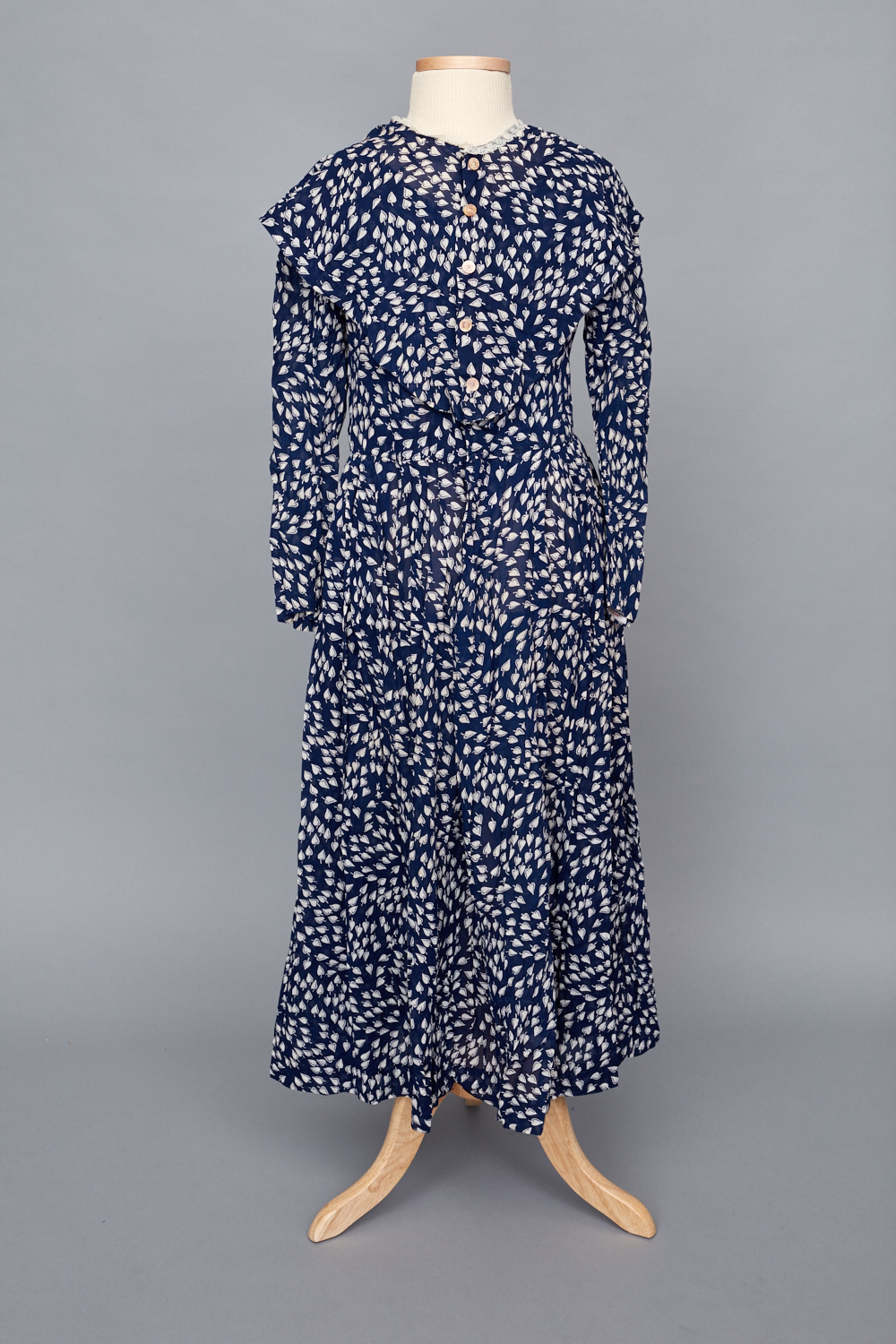 A blue and white floral dress on a mannequin.