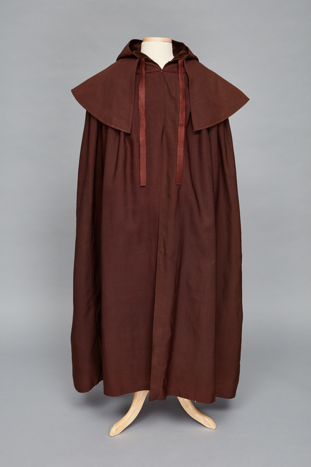 A brown cloak on a mannequin.
