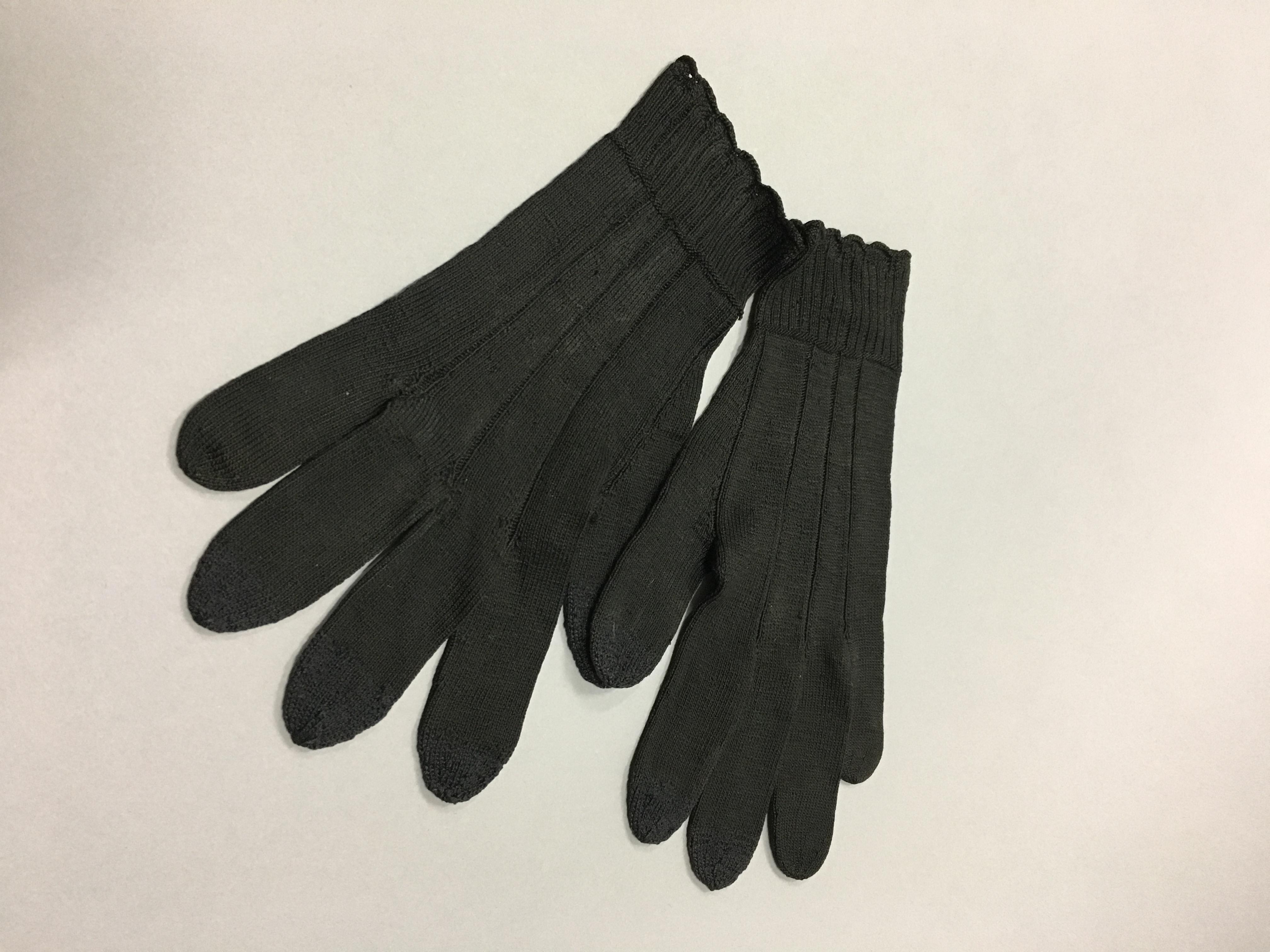 A pair of black gloves on a white surface.