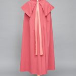 A pink cape on a mannequin.