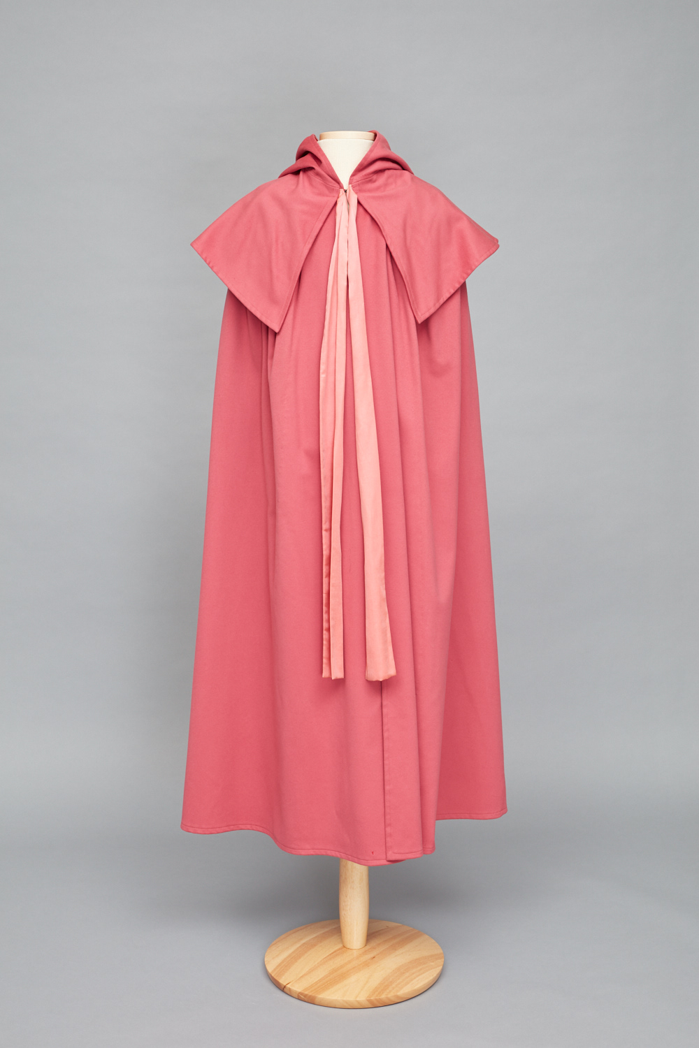 A pink cape on a mannequin.