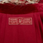 A red velvet dress with a label on it.