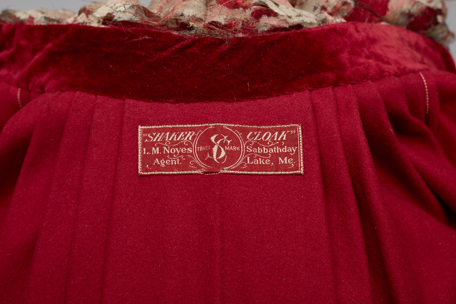 A red velvet dress with a label on it.