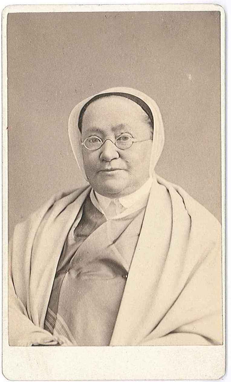 An old photo of a woman in a white robe.