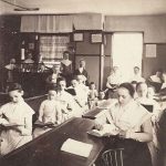 A group of women sitting at desks in a classroom.