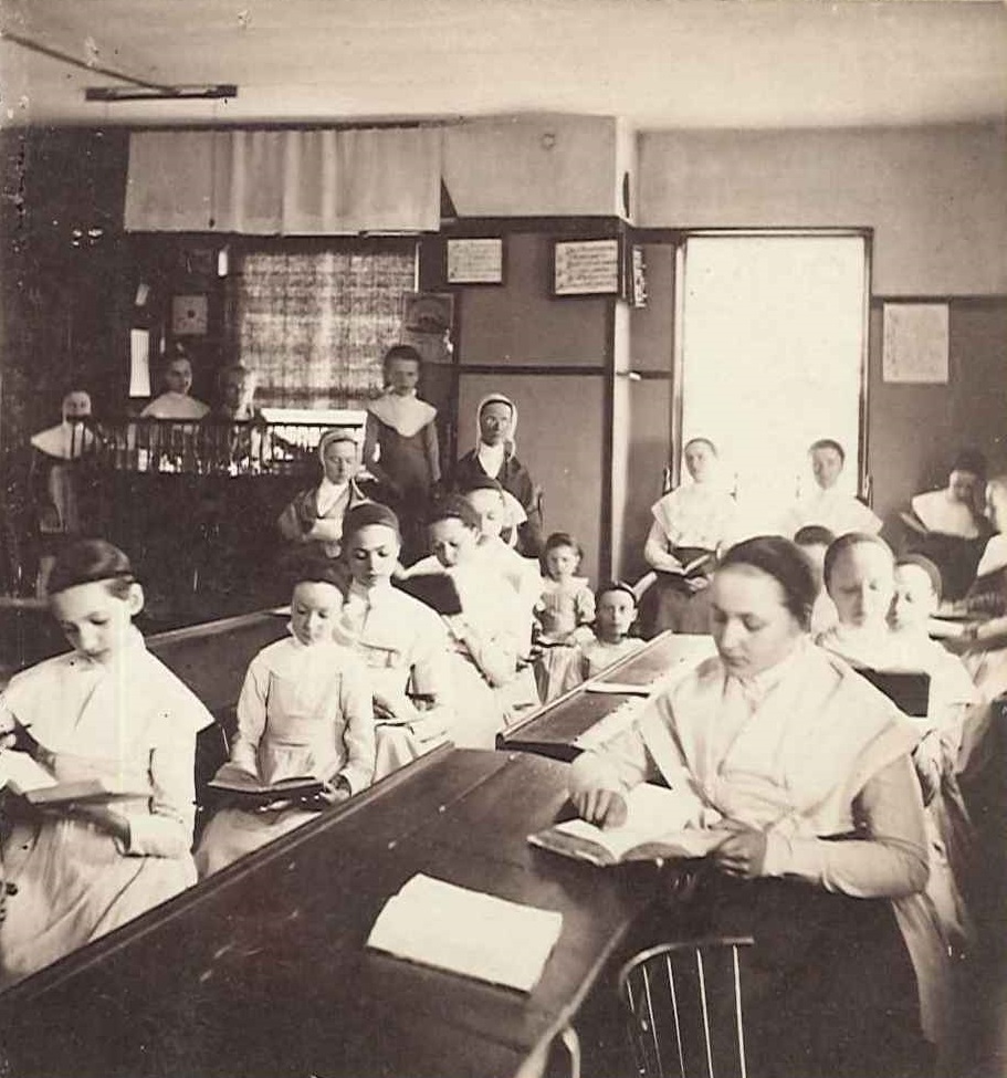 A group of women sitting at desks in a classroom.