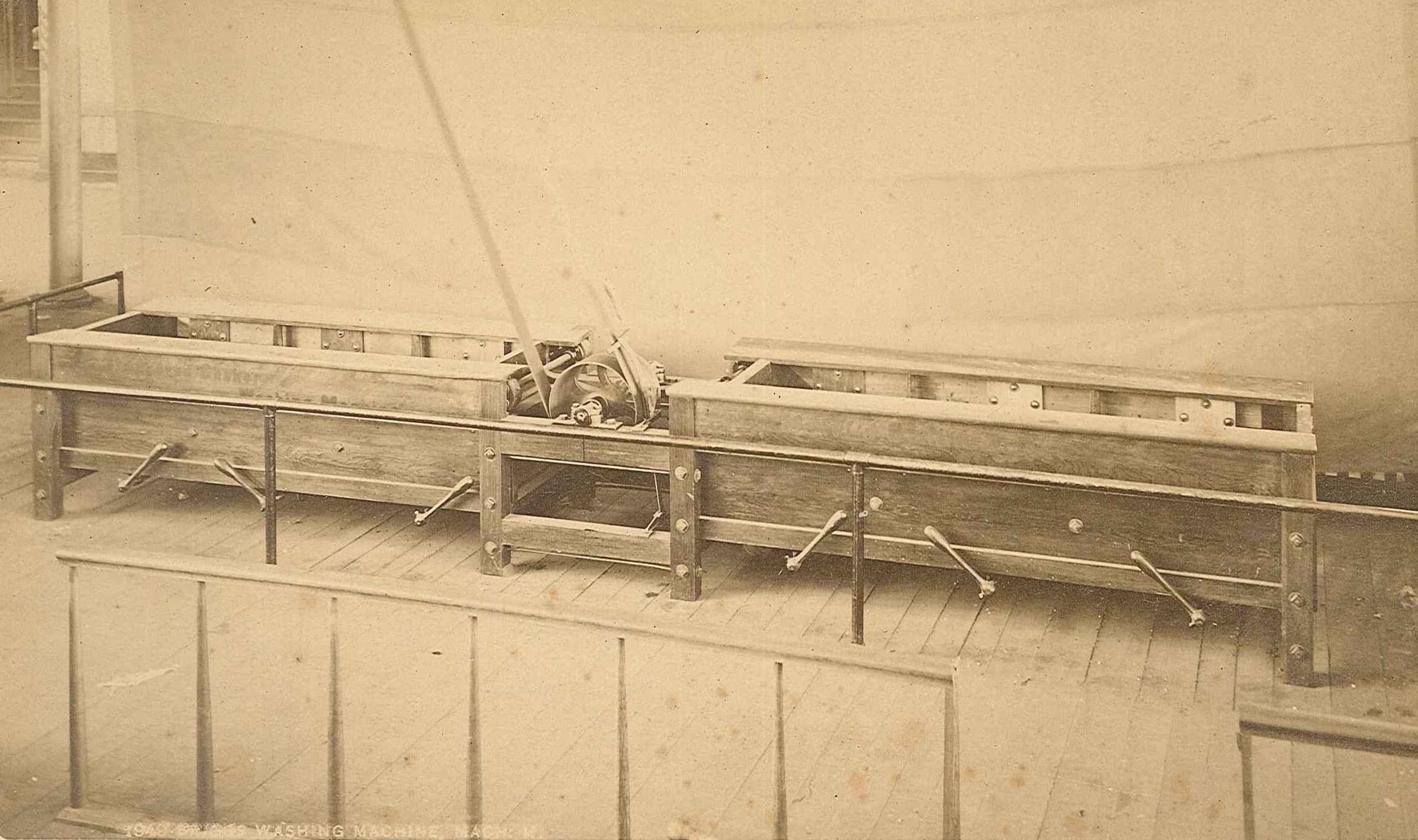 An old photo of a wooden bed in a room.