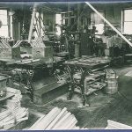 A black and white photo of a woodworking shop.