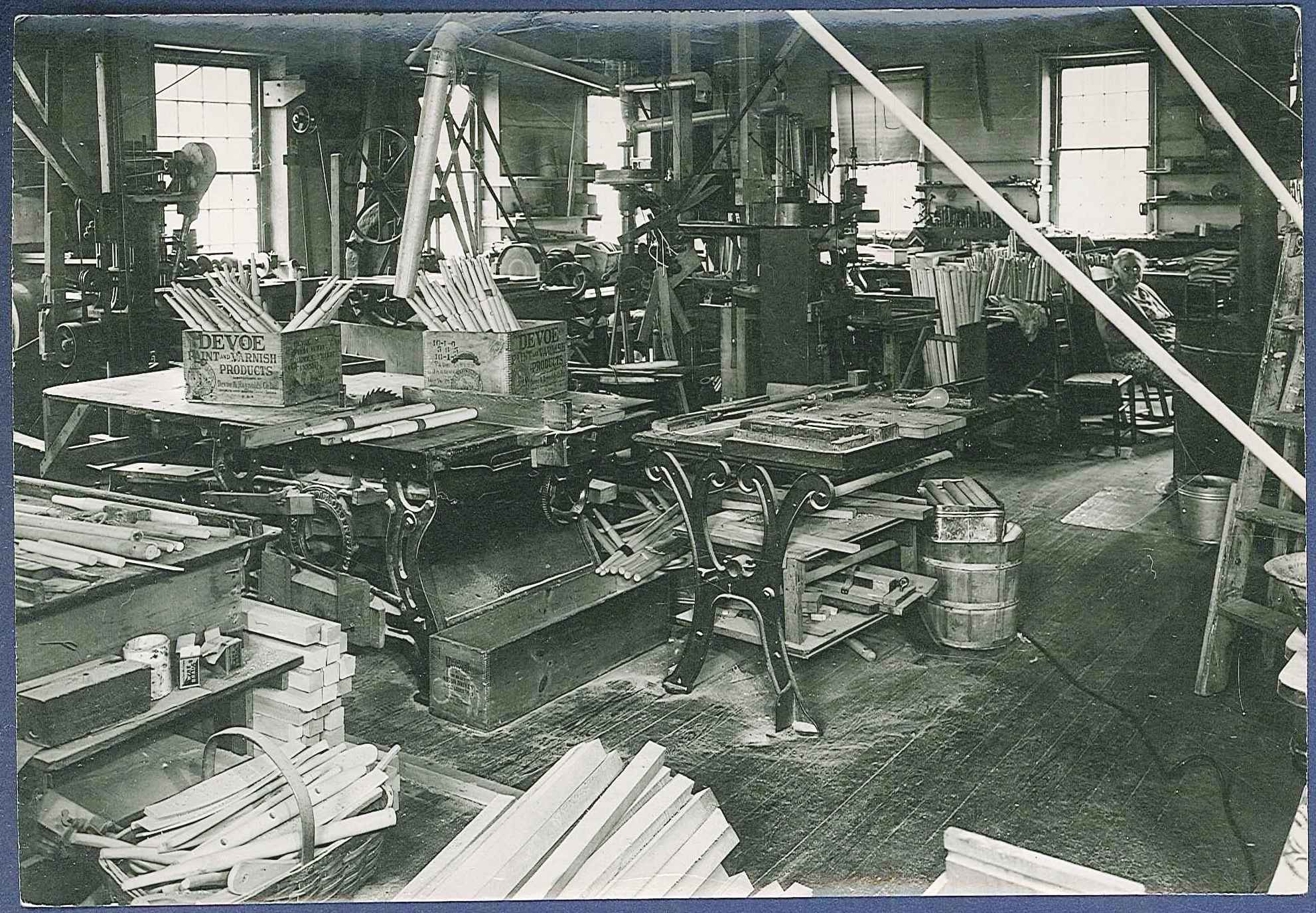 A black and white photo of a woodworking shop.