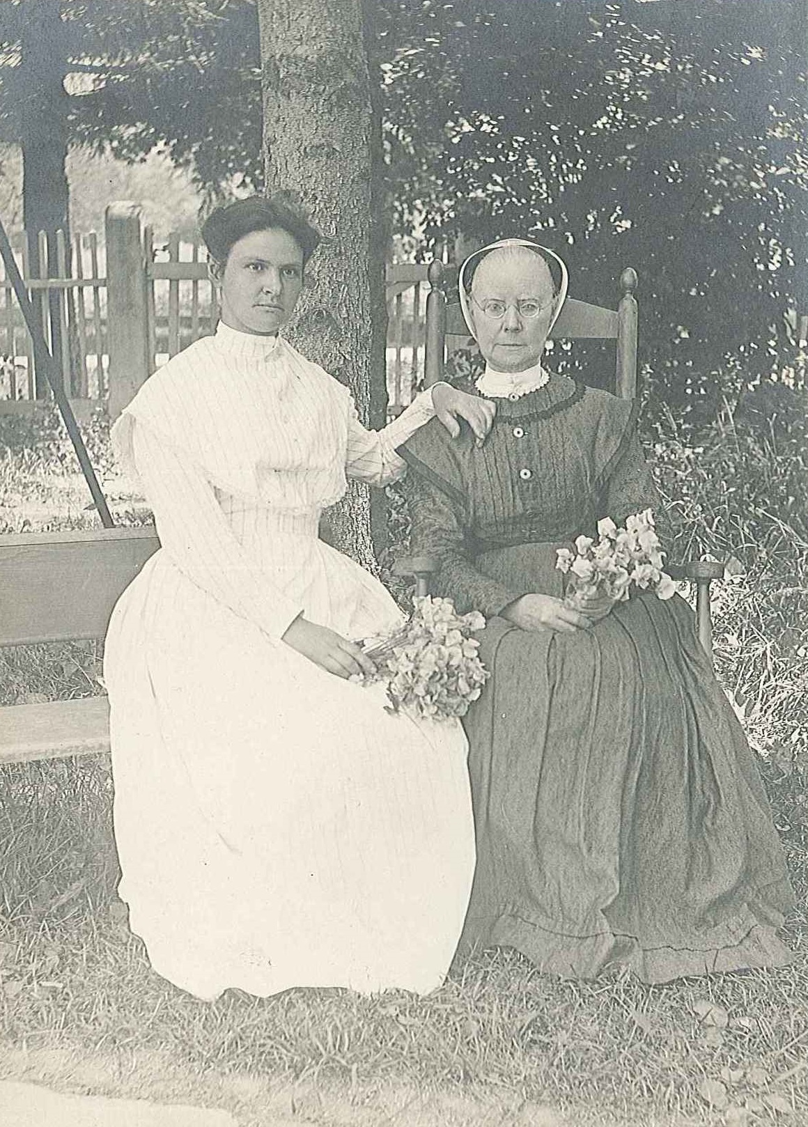 Two women sitting on a bench.