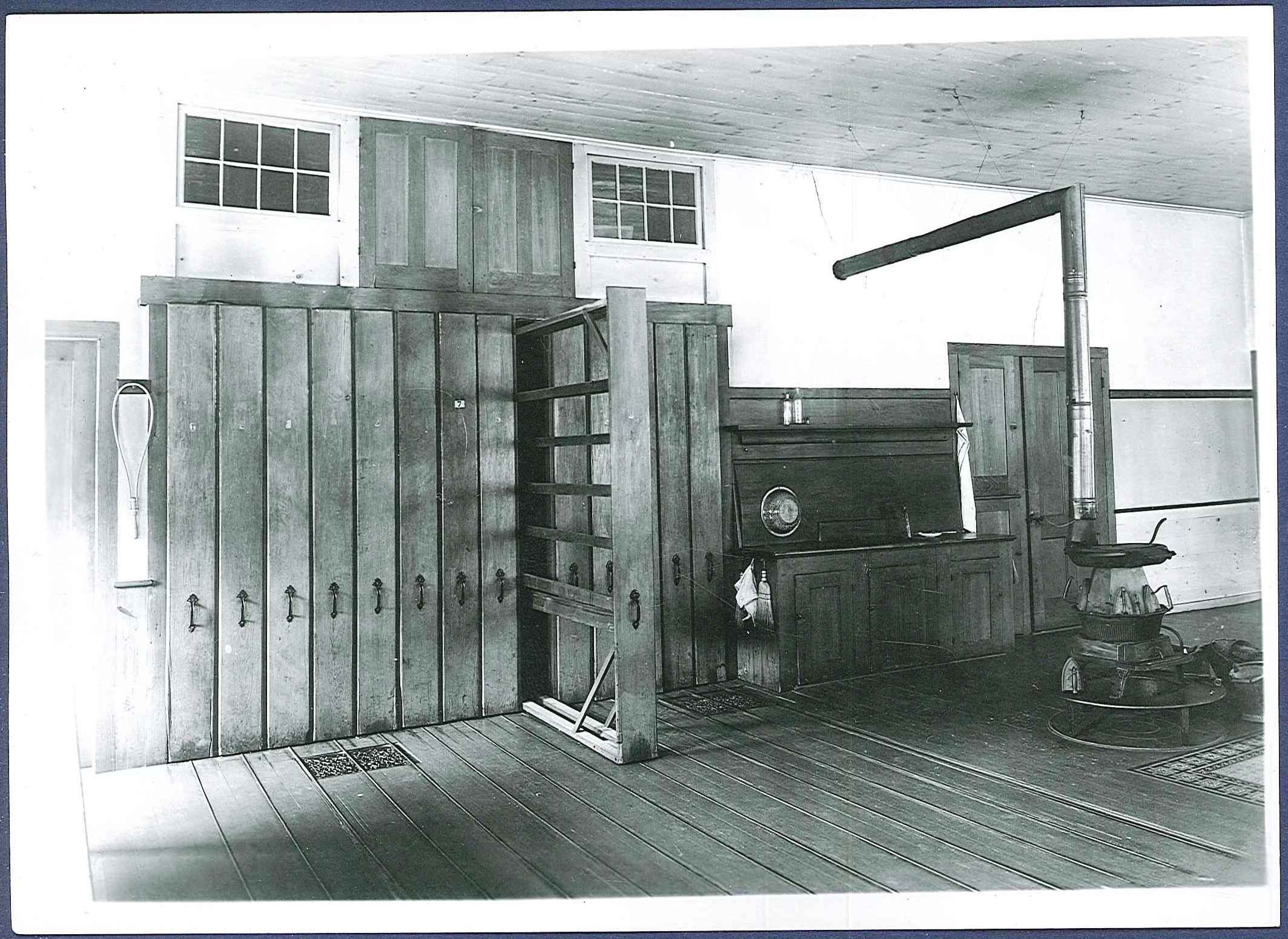 An old photo of a room with wooden floors.