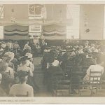 An old photo of a church with people sitting in the pews.