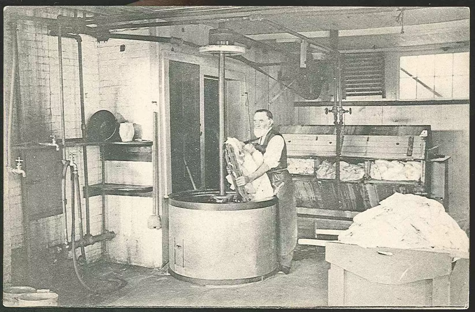 An old photo of a man working in a factory.