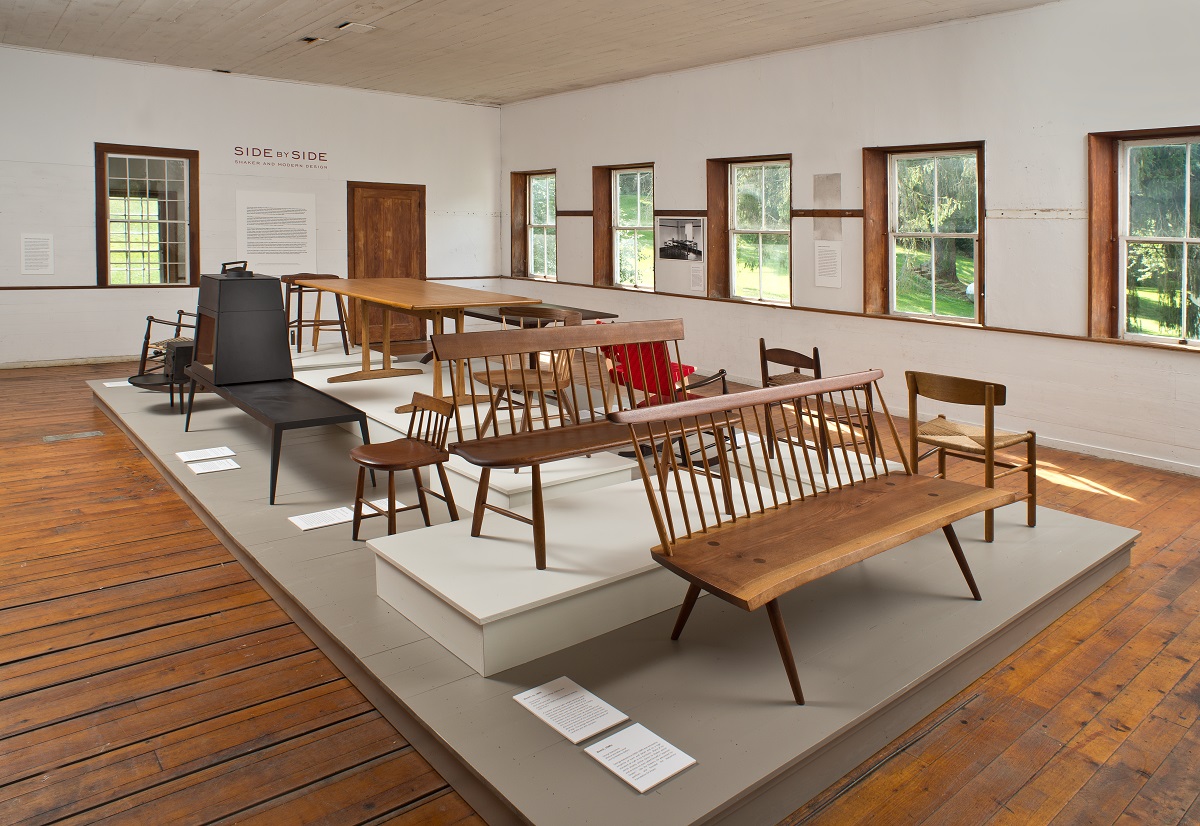 A room with a lot of wooden chairs on display.