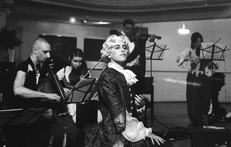 A black and white photo of a group of people in a room.