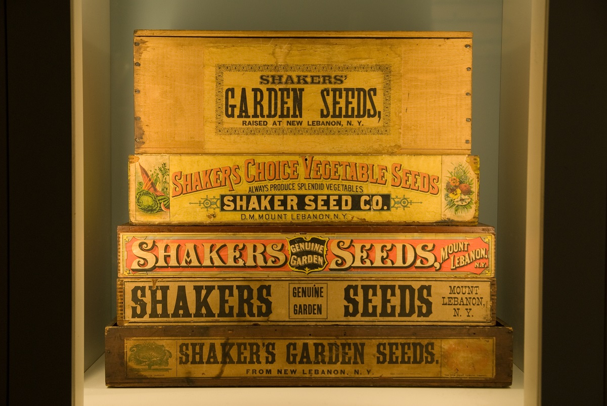 A stack of wooden boxes on display in a museum.